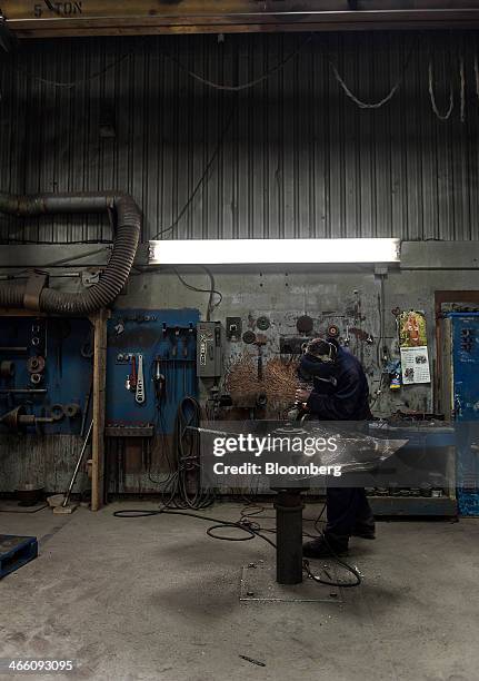 Worker sands propeller blades at the Osborne Propellers Ltd. Facility in North Vancouver, British Columbia, Canada, on Wednesday, Jan. 29, 2014....