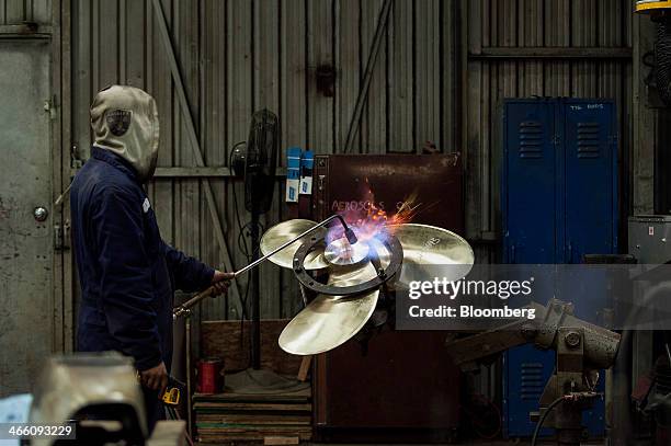 Worker heats a propeller core at the Osborne Propellers Ltd. Facility in North Vancouver, British Columbia, Canada, on Wednesday, Jan. 29, 2014....