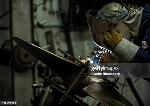 Worker welds a propeller core at the Osborne Propellers Ltd. Facility in North Vancouver, British Columbia, Canada, on Wednesday, Jan. 29, 2014....