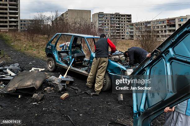 Gipsy men dismantle a used car to recycle metals in the Gipsy ghetto of Chanov on outskirts of Most, Czech Republic, 26 March 2008.