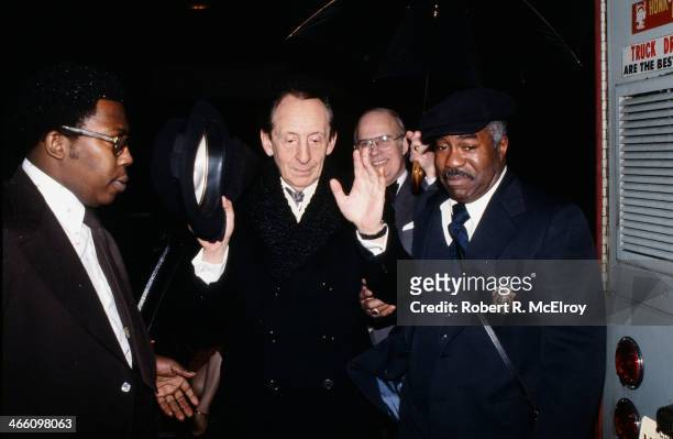 Police officer escorts Russian-born American pianist Vladimir Horowitz into Carnegie Hall, January 8, 1978.