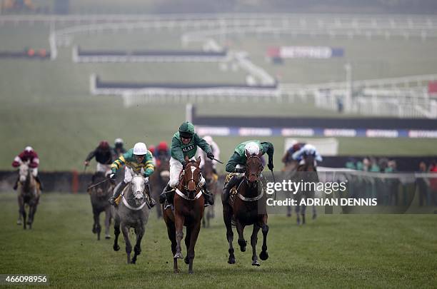 Jockey Barry Geraghty riding Peace and Co. On his way to winning the JCB Triumph Hurdle Race on the final day of the Cheltenham Festival horse racing...