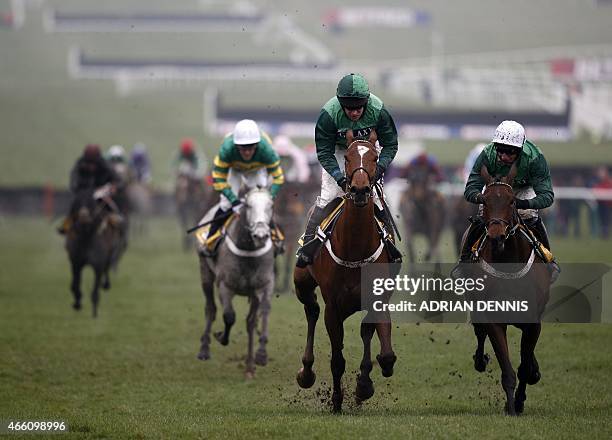 Jockey Barry Geraghty riding Peace and Co. On his way to winning the JCB Triumph Hurdle Race on the final day of the Cheltenham Festival horse racing...