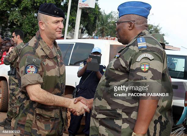 French commandant of the Sangaris operation Eric Bellot des Minieres shake hands with Commandant of the Centrafrican gendarmerie Guy Bertrand Damango...