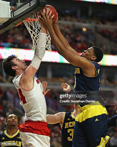 Frank Kaminsky of the Wisconsin Badgers and Kameron Chatman of the Michigan Wolverines battle for a rebound during the quarterfinal round of the 2015...