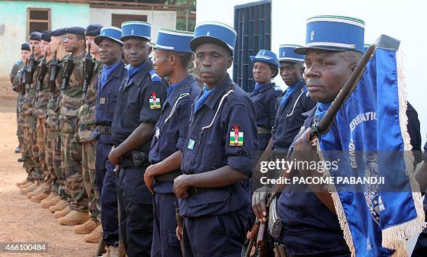 French troops and Centrafrican gendarmes stand during the power transfer ceremony on March 13, 2015 in the PK12 district in Bangui. Paris announced...