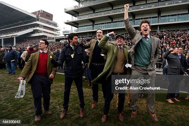 Racegoers cheer home a winner during Gold Cup day at the Cheltenham Festival at Cheltenham racecourse on March 13, 2015 in Cheltenham, England.