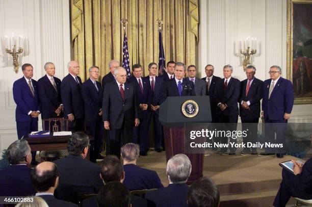 President George W. Bush speaks before signing the Patriot Act Anti-Terrorism bill in the East Room of the White House, as Vice President Dick Cheney...