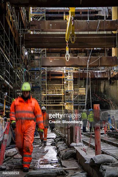 Workers operate in the main tunnel access hole during construction of the new city Metro line at Noerrebroparken in Copenhagen, Denmark, on Thursday,...