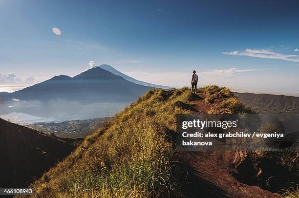 hiker staying on top of  mount batur - bali volcano stock pictures, royalty-free photos & images