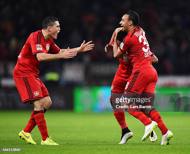 Wendell of Bayer 04 Leverkusen is congratulated by Kyriakos Papadopoulos and Karim Bellarbi after scoring the first goal during the Bundesliga match...