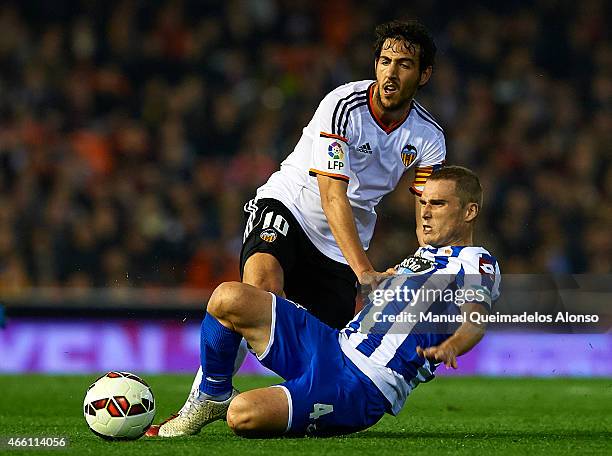 Dani Parejo of Valencia competes for the ball with Alex Bergantinos of Deportivo de La Coruna during the La Liga match between Valencia CF and RC...