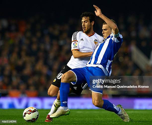 Dani Parejo of Valencia competes for the ball with Alex Bergantinos of Deportivo de La Coruna during the La Liga match between Valencia CF and RC...