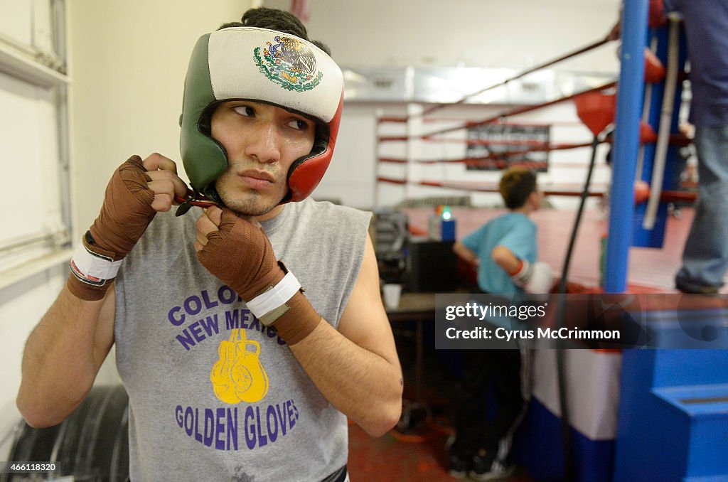 Golden Gloves boxer Eusbaldo Ramirez, 18, gets his head gear ready to spar at the Colorado Golden Gloves Gym in Wheat Ridge.