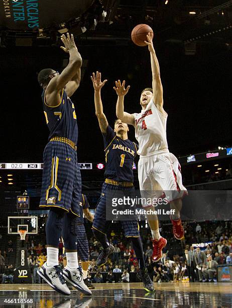 Tyler Kalinoski of the Davidson Wildcats makes the game winning shot over Jerrell Wright of the La Salle Explorers with no time on the clock in the...