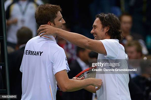 Florian Mayer of Germany and head coach Carsten Arriens hug on day 1 of the Davis Cup First Round match between Germany and Spain at Fraport Arena on...