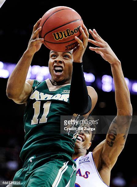 Lester Medford of the Baylor Bears goes up against Kelly Oubre Jr. #12 of the Kansas Jayhawks in the first half during a semifinal game of the 2015...