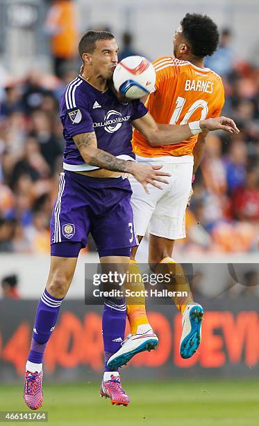 Seb Hines of the Orlando City SC battles for the ball with Giles Barnes of the Houston Dynamo during their game at BBVA Compass Stadium on March 13,...