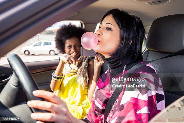 woman playing with chewing gum on a road trip - driving humor stock pictures, royalty-free photos & images