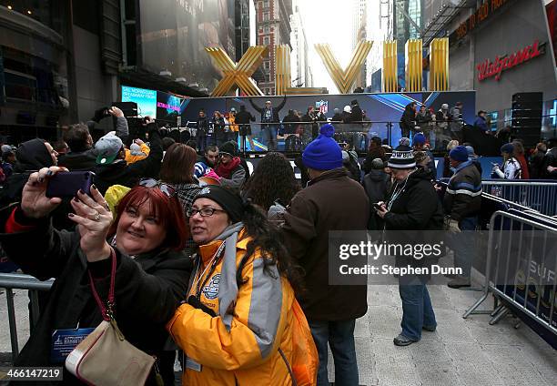 Fans take a self portrait by Super Bowl signage in Times Square prior to Super Bowl XLVIII at MetLife Stadium on January 31, 2014 in New York City.