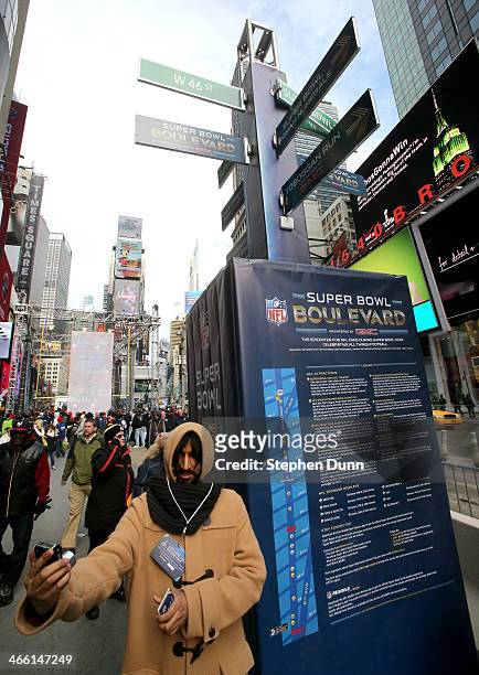 Fan takes a self portrait by Super Bowl signage in Times Square prior to Super Bowl XLVIII at MetLife Stadium on January 31, 2014 in New York City.