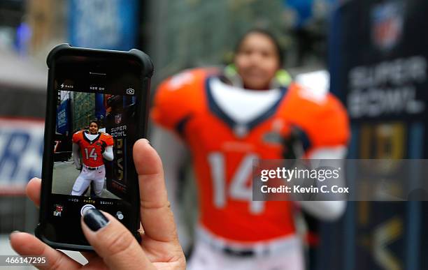 Fans enjoy festivities in Times Square on January 31, 2014 in New York City. Broadway has temporarily been re-named Super Bowl Boulevard as the city...