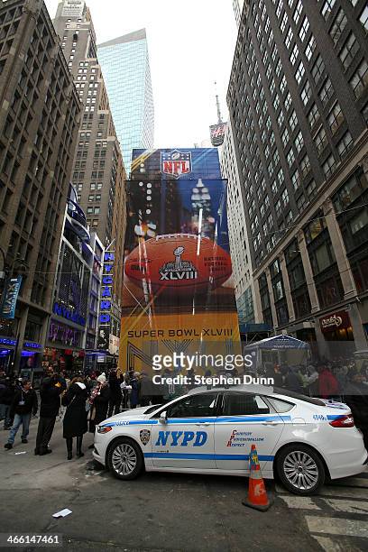 An NYPD car sits in front of Super Bowl signage in Times Square prior to Super Bowl XLVIII at MetLife Stadium on January 31, 2014 in New York City.
