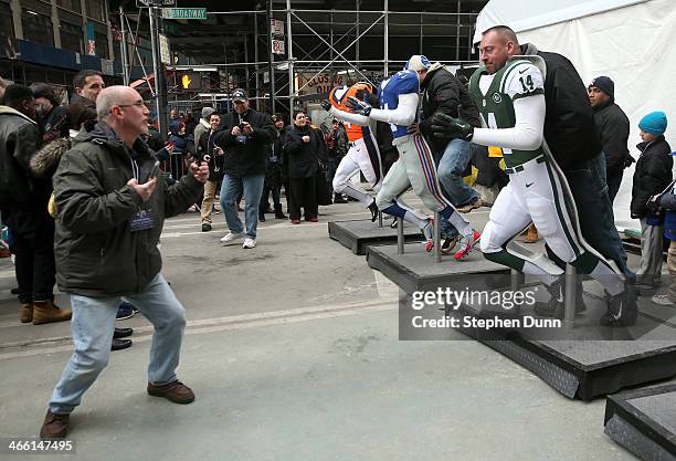 Fans pose for photos on Super Bowl action figures on Super Bowl Boulevard prior to Super Bowl XLVIII at MetLife Stadium on January 31, 2014 in New...