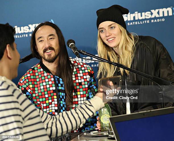 Steve Aoki and model Tiernan Cowling visit the SiriusXM Studios on March 13, 2015 in New York City.