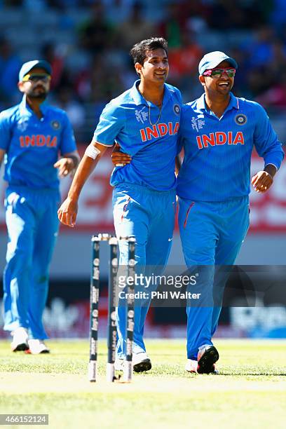 Mohit Sharma of India is congratulated by Suresh Raina for taking the wicket of Solomon Mire of Zimbabwe during the 2015 ICC Cricket World Cup match...