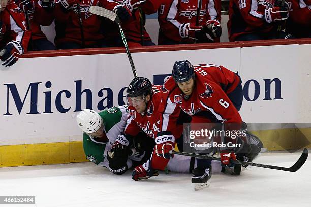 Tom Wilson and Tim Gleason of the Washington Capitals check Patrik Nemeth of the Dallas Stars during the third period of the Stars 4-2 win at Verizon...