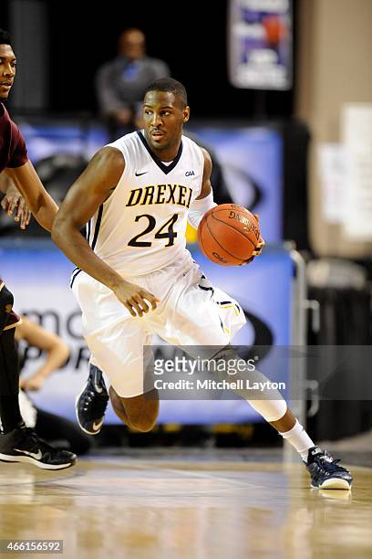 Rodney Williams of the Drexel Dragons dribbles the ball during the first round of the CAA Basketball Tournament against the Charleston Cougars at the...