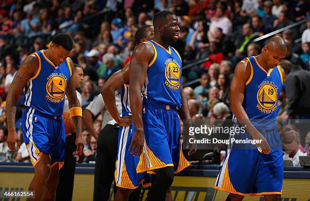 Brandon Rush, Draymond Green and Leandro Barbosa of the Golden State Warriors head to the bench for a timeout against the Denver Nuggets at Pepsi...