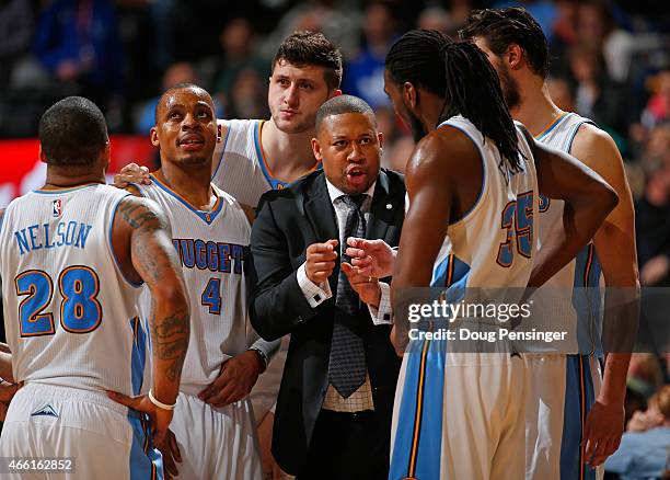 Interim head coach Melvin Hunt of the Denver Nuggets leads Jameer Nelson, Randy Foye, Jusuf Nurkic, Kenneth Faried and Danilo Gallinari of the Denver...