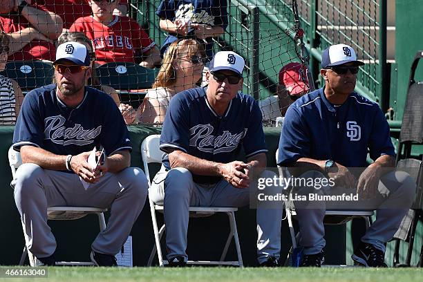 Hitting coach Mark Kotsay, manager Bud Black and bench coach Dave Roberts of the San Diego Padres look on during the game against the Los Angeles...