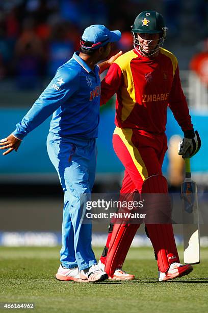 Brendan Taylor of Zimbabwe is congratulated by Suresh Raina of Zimbabwe as he leaves the field after making 138 runs during the 2015 ICC Cricket...