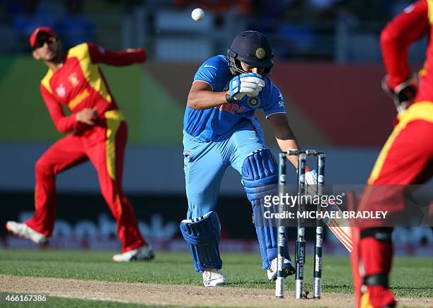 Zimbabwe's Tawanda Mupariwa fires the ball at the wickets as India's Rohit Sharma looks to make a run during the Pool B Cricket World Cup match...