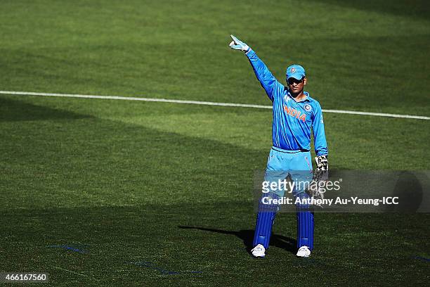 Dhoni of India puts his team in order during the 2015 ICC Cricket World Cup match between India and Zimbabwe at Eden Park on March 14, 2015 in...