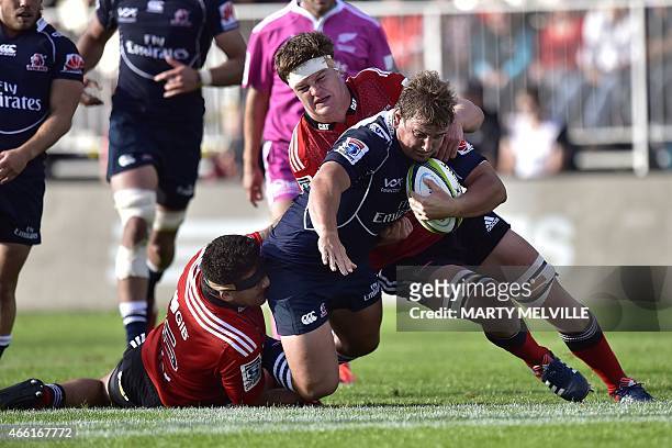 Lions' Ruan Dreyer is tackled by Crusaders' Cosie Taylor and Andries Ferreira during the Super 15 Rugby Union match between the Crusaders against RSA...