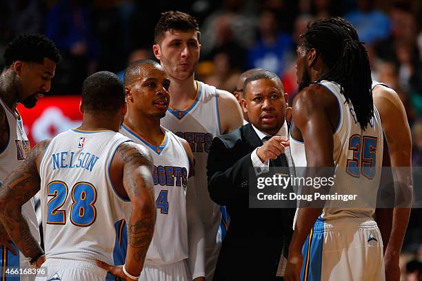 Interim head coach Melvin Hunt of the Denver Nuggets leads Jameer Nelson, Randy Foye, Jusuf Nurkic, Kenneth Faried and Danilo Gallinari of the Denver...