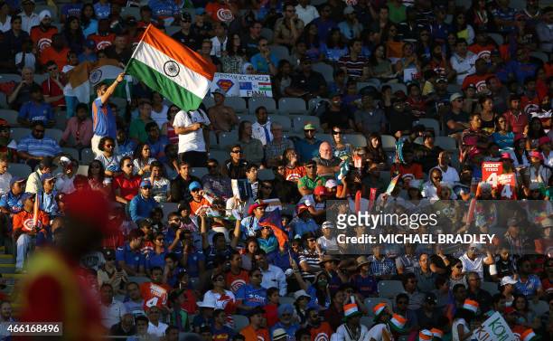 An Indian flag flies in the crowd during the Pool B Cricket World Cup match between India and Zimbabwe at Eden Park in Auckland on March 14, 2015....