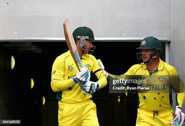 Michael Clarke and Aaron Finch of Australia walk out to open the batting during the 2015 Cricket World Cup match between Australia and Scotland at...