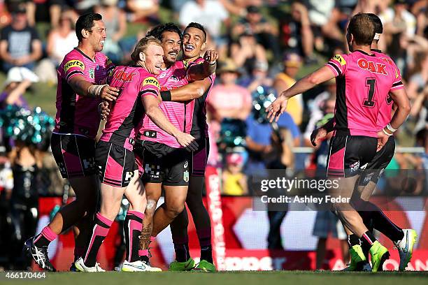 Panthers team mates celebrate a try during the round two NRL match between the Penrith Panthers and the Gold Coast Titans at Carrington Park on March...