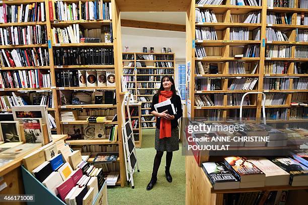 Christine Rey, new owner of the bookstore "Le Bleuet" poses on February 17, 2015 in her bookstore in the small Provence's village of Banon, southern...