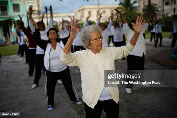 Flora Medina lifts her arms in a Tai-Chi motion during a circulo de abuelos in Villalon Park, located in the neighborhood of Verdado in Havana, Cuba....