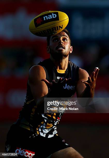 Sam Lloyd of the Tigers takes a mark during the NAB Challenge AFL match between the Richmond Tigers and Port Adelaide Power at Lavington Sports...