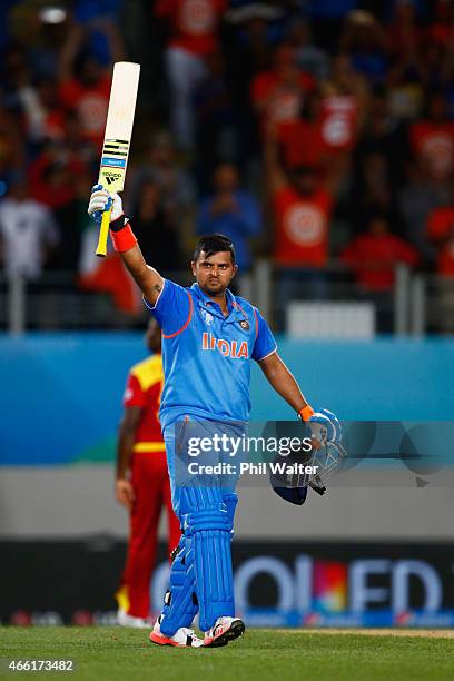 Suresh Raina of India celebrates his century during the 2015 ICC Cricket World Cup match between India and Zimbabwe at Eden Park on March 14, 2015 in...