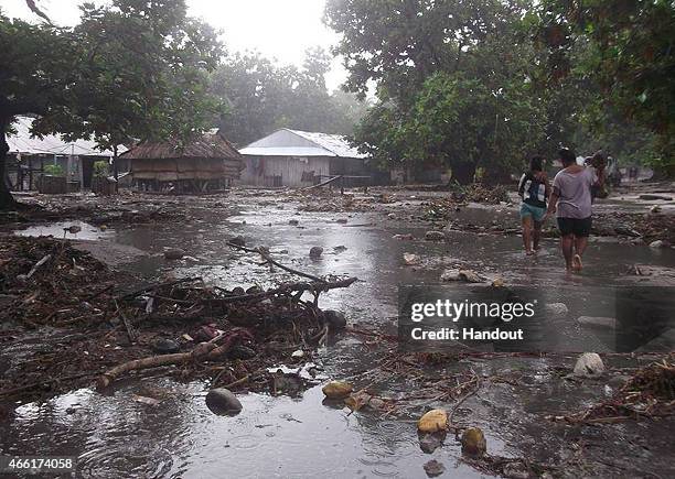In this handout image provided by Plan International Australia, debris is left by a strom surge after flood waters moved inland, March 14, 2015 on...