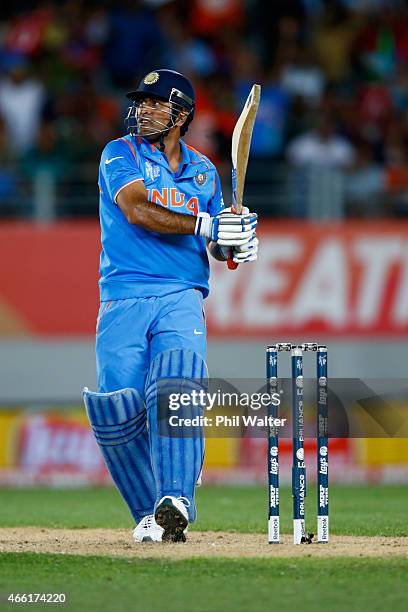 Dhoni of India hits the winning runs during the 2015 ICC Cricket World Cup match between India and Zimbabwe at Eden Park on March 14, 2015 in...