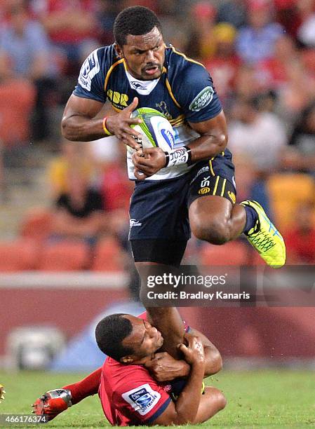 Henry Speight of the Brumbies skips out of the tackle by Will Genia of the Reds during the round five Super Rugby match between the Reds and the...